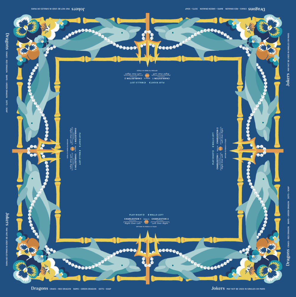 Delta Delta Delta MIGTM Mahjong Mat featuring a symmetrical graphic design with a central empty square, surrounded by a border of gold bamboo, sea turtles, white pearls, and small orange-and-white fish. The brand name 'Jolbert's' is printed in the corners.