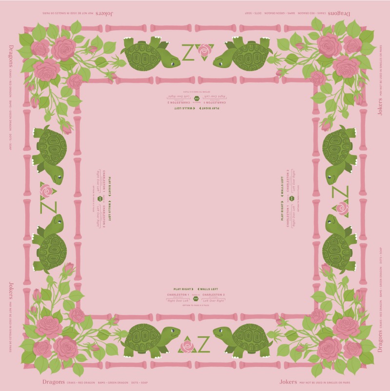 Delta Zeta MIGTM Mahjong Mat design featuring a decorative border with green turtles, pink roses, bamboo stalks, and the letter Z, with small printed text around the edges.