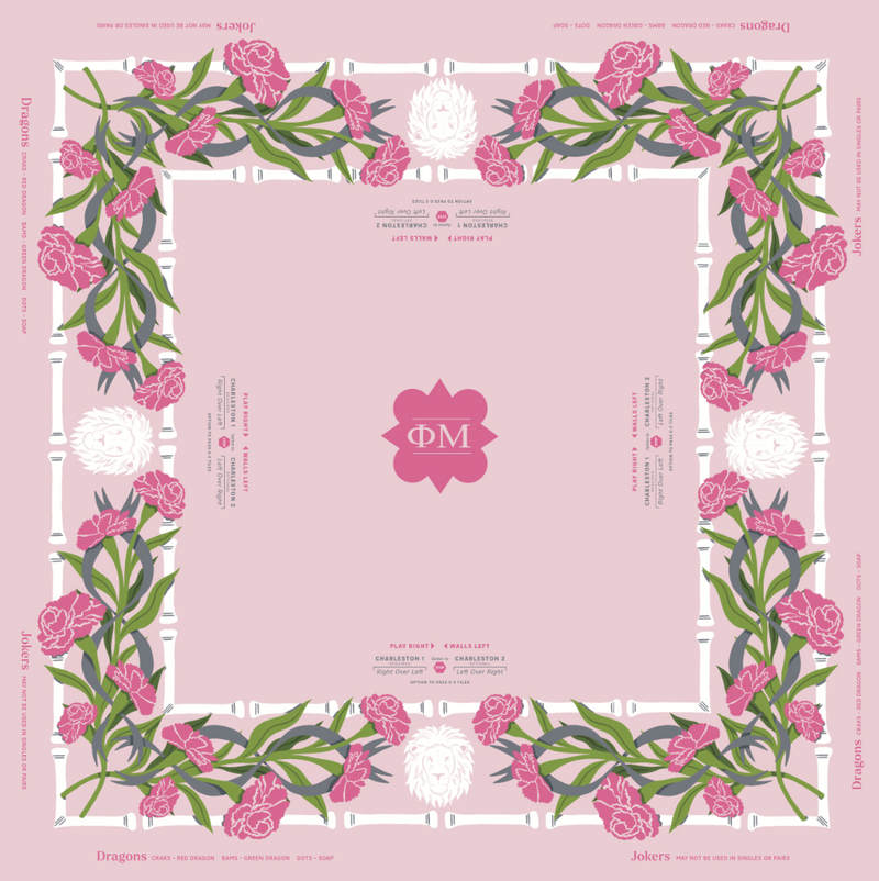 Phi Mu MIGTM Mahjong Mat featuring a floral border design with pink flowers, green leaves, and white accents, with Greek letters Phi and Mu in the center and printed text around the edges.